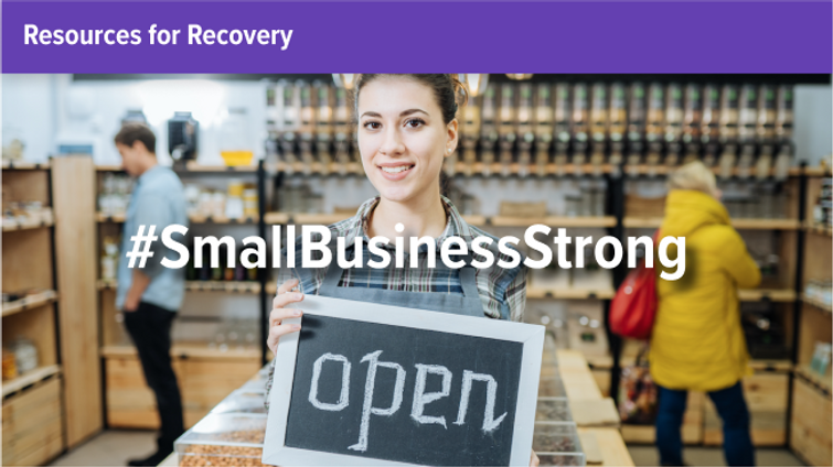 Female small business owner holding open sign in front of store with two other shoppers 