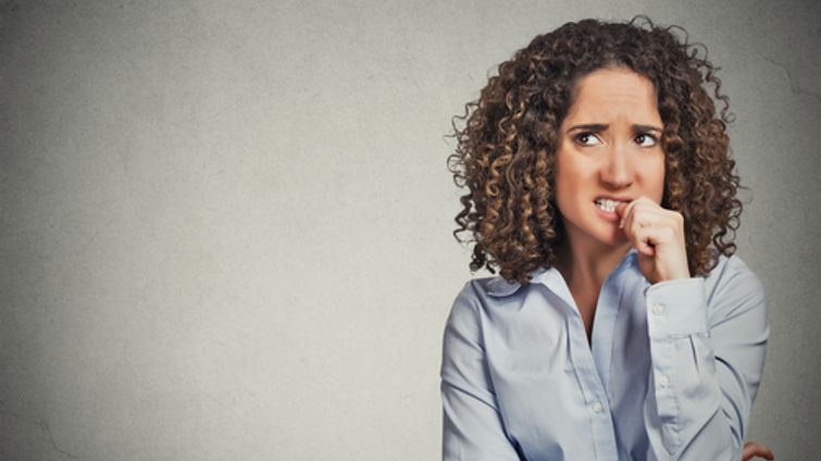 nervous woman biting her nails