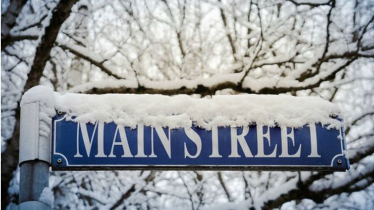 main street sign covered in snow