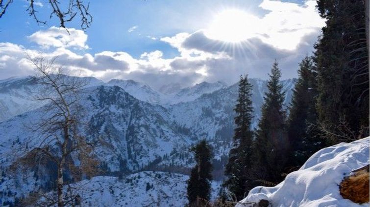 mountains with clouds showing bright sun silver linings