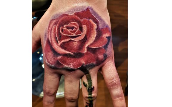 rose cover up tattoo on hand