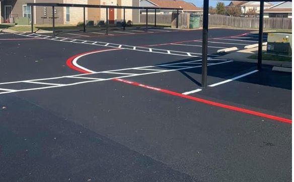 Sealcoat of asphalt pavement  by Sealcoat Specialists LLC