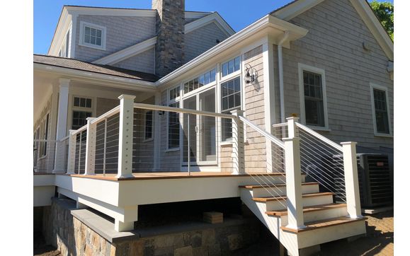 Ipê deck and cable railings  by Wolf Carpentry Inc.