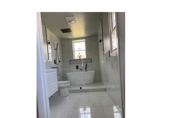 Beautiful and modern with free standing tub master bathroom  by FLX construction llc