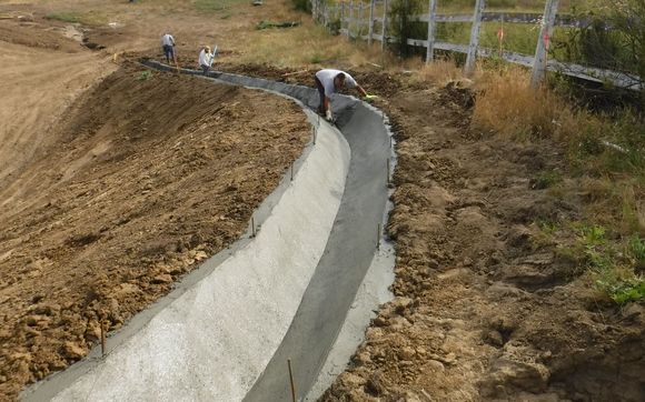 Concrete Drainage Ditch with River rock by Shotcrete Lining Systems ...