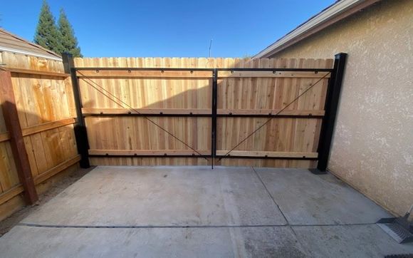 Wood gate with Metal framing  by J & D Fence & Construction Inc.
