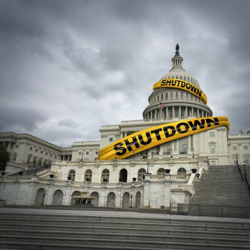 U.S. Capitol Building wrapped in yellow tape that says 'SHUTDOWN'