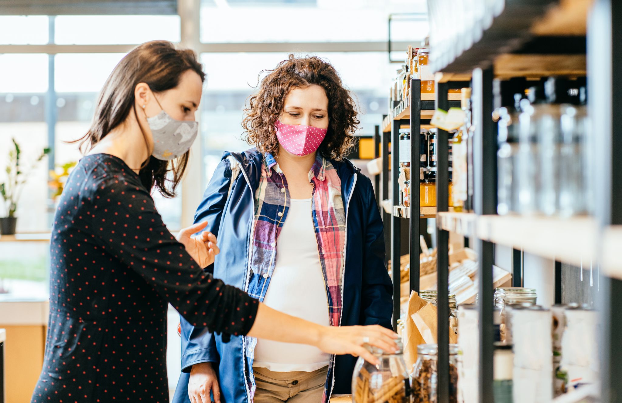 Women shopping in local store with masks on