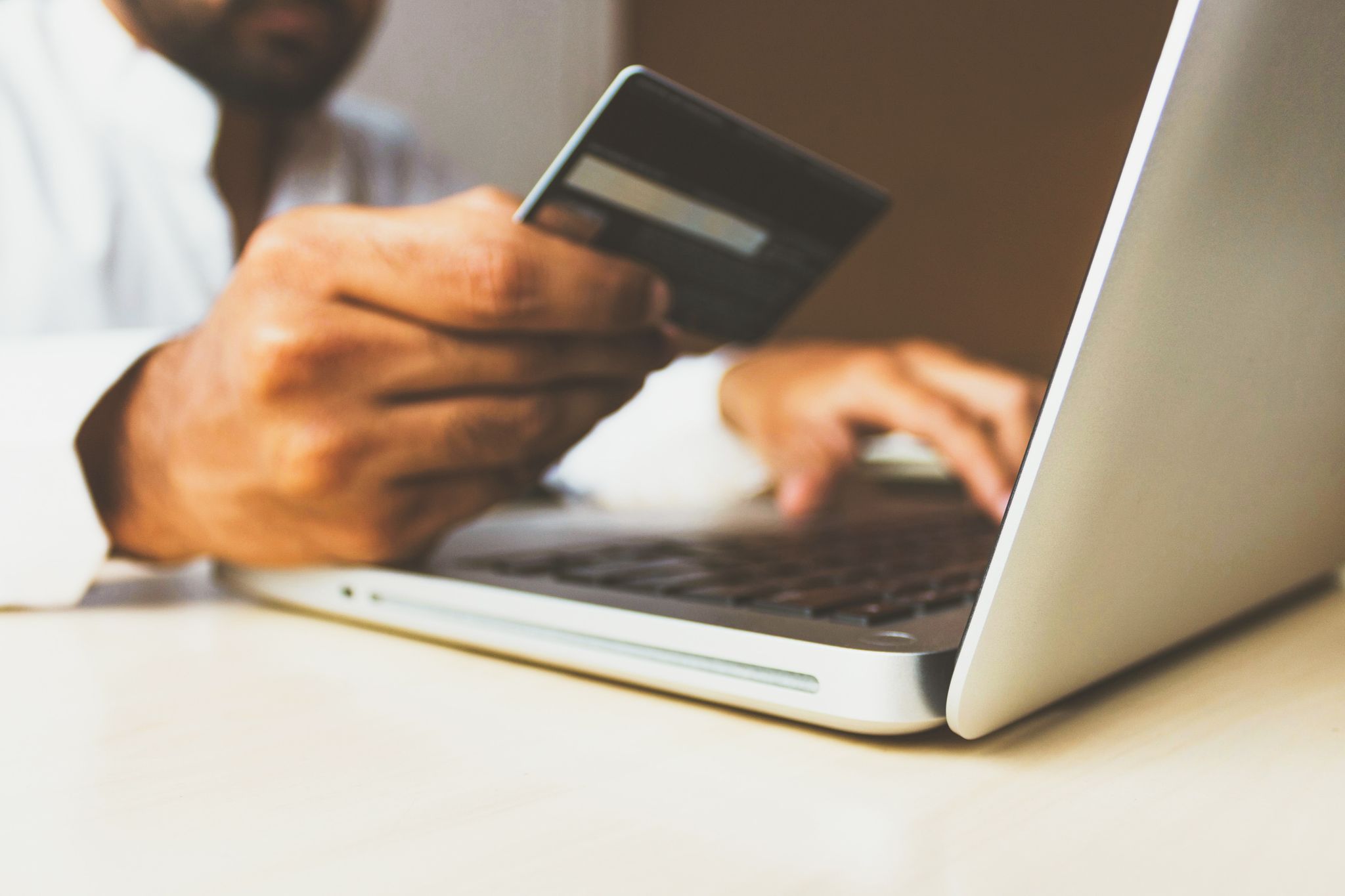 man holding credit card showing how to ramp up online sales