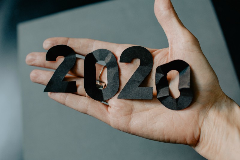 hand holding up crumpled up 2020 numbers