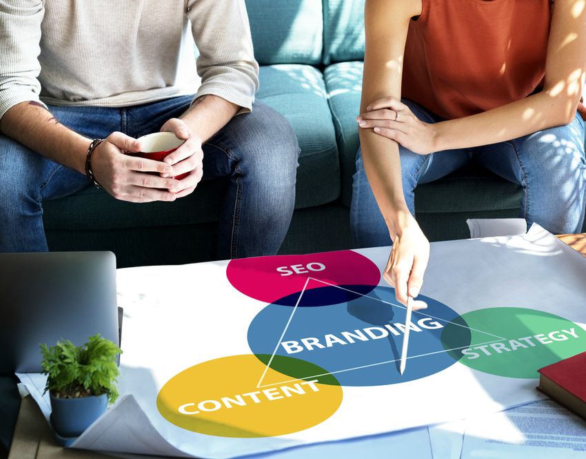 two people pointing at content strategy for small business
