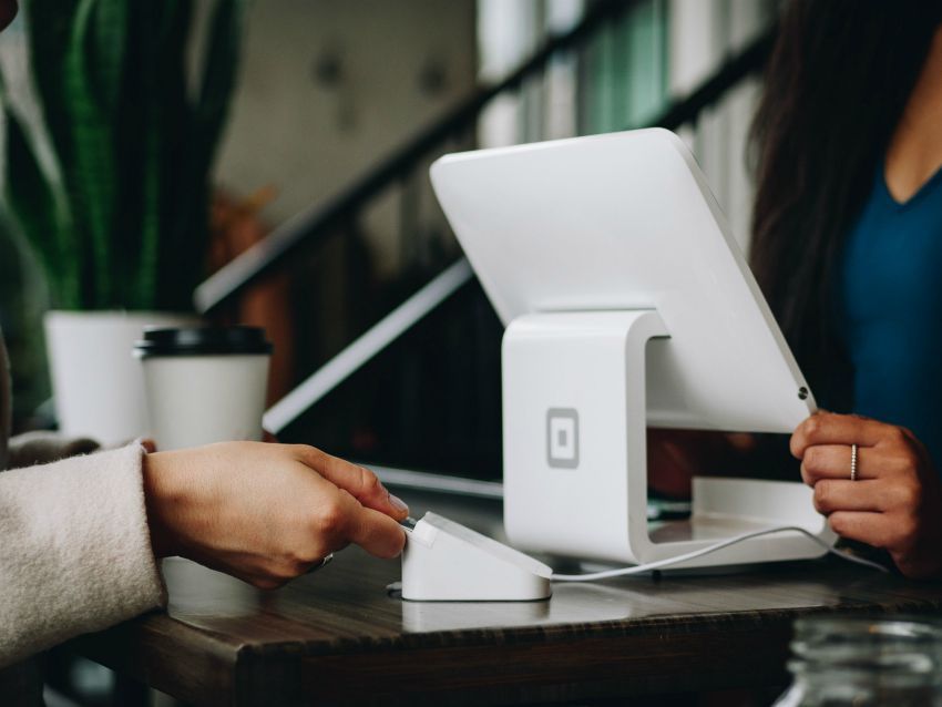 person paying with a credit card at small business