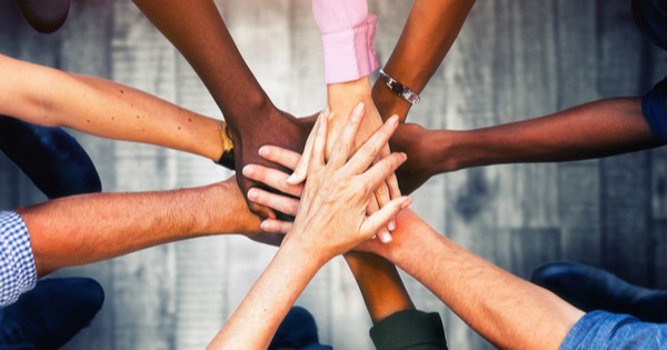 diverse hands on top of each other community concept